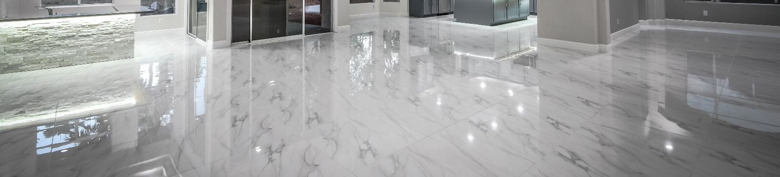Spacious Valencia living room with polished marble tile flooring installed by expert contractors.