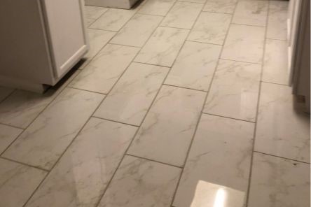 Polished marble tiles and granite countertops highlighting the modern design in Joseph Rodriguez’s Santa Clarita kitchen.