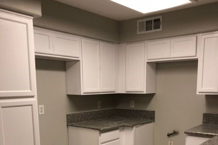 Newly remodeled Santa Clarita kitchen with marble pattern tile flooring and sleek custom cabinets.